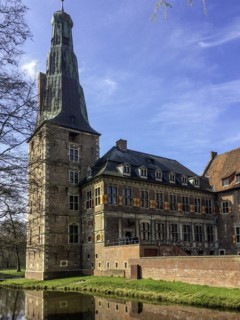 View of tower and main wing of historic moated castle from Renaissance Raesfeld Castle, in the