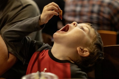 Denver, Colorado, Hendrix Hjermstad, 5, savors bacon at breakfast