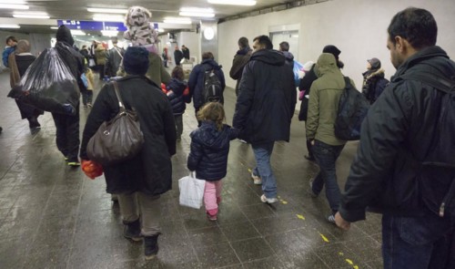Refugees have arrived at Schoenefeld station on an IC train. They are then taken by bus to