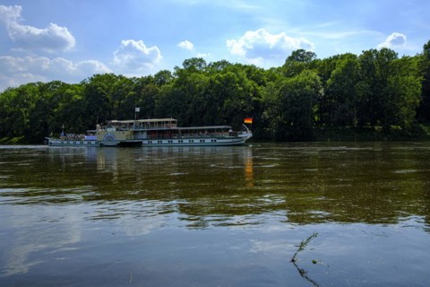 The historic paddle steamer KURORT RATHEN travelling backwards on the Elbe at the steamboat landing