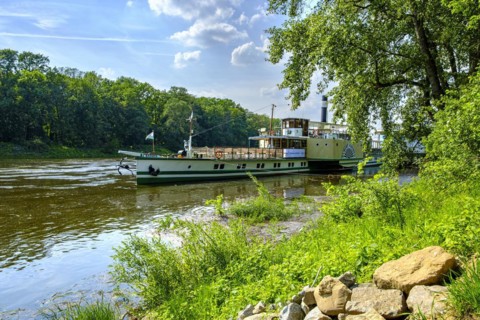 The historic paddle steamer KURORT RATHEN has docked at the steamer landing stage in Pillnitz,
