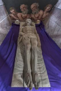 Reclining figure of Christ in the Holy Sepulchre, behind a motif of three men in purgatory, St