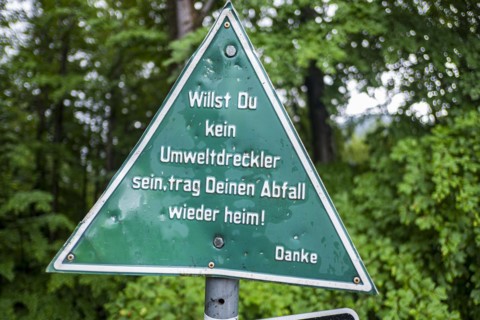 Keeping the environment clean, message to polluters and cyclists on a sign at the upper entrance to