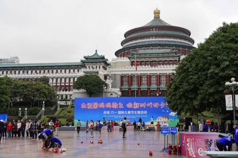 Chongqing, Chongqing Province, China, Asia, People on a square with a prominent building in the