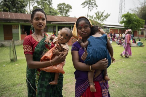 BOKAKHAT, INDIA, APRIL 19: Women with child show their marked finger after casting their votes