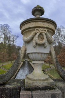 View from a stone bridge with an ornamental vase onto a canal in the castle park, Ludwigslust,