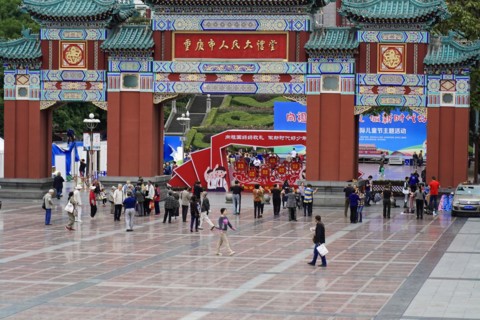 Chongqing, Chongqing Province, China, Asia, Crowds of people move towards a magnificent Chinese