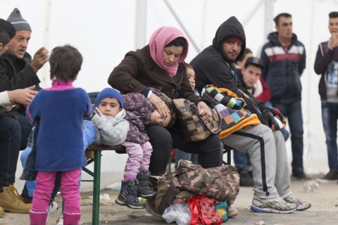 A Syrian refugee family and their children wait in a tent at the Berlin State Office for Health and