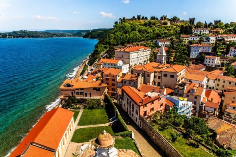 View from the bell tower over Piran with city walls and castle, harbour town of Piran on the