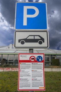 Parking sign and warning sign of the Federal Government for nutrition against discarded food,