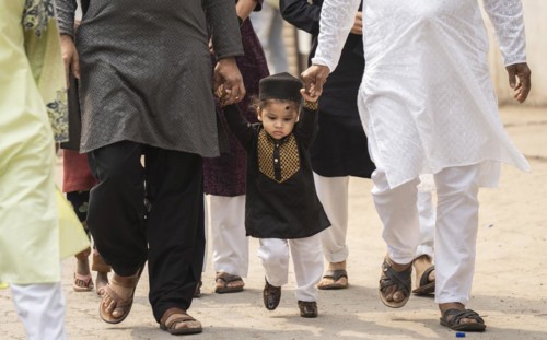 GUWAHATI, INDIA, APRIL 11: Muslim people with children walk towards an Eidgah to perform Eid