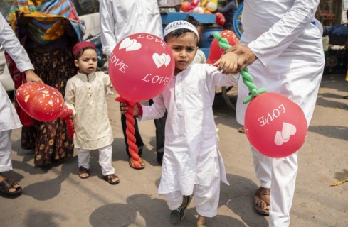 GUWAHATI, INDIA, APRIL 11: Muslim people with children walk towards an Eidgah to perform Eid
