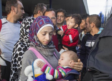 Syrian refugees have arrived at Schoenefeld station on a special train. They are then taken by bus