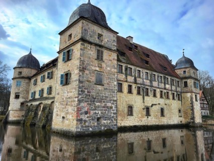 Mitwitz moated castle under a cloudy sky. Mitwitz, Kronach, Upper Franconia, Bavaria, Germany,