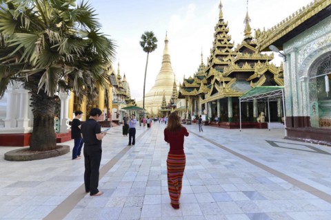 Shwedagon Pagoda, Yangon, Myanmar, Asia, people visiting a large pagoda, some taking photos, Asia