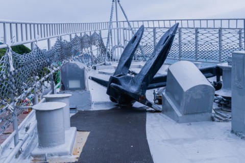 Large black anchor on deck of battleship on display at Unification Park in Gangneung, South Korea,