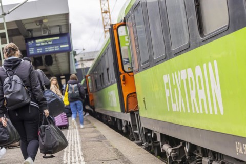 Flixtrain train at Stuttgart main station, track apron with arriving and departing trains,
