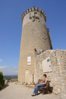 Woman on a bench in front of the castle, Chateaurenard, Bouches-du-Rhone, Provence-Alpes-Cote