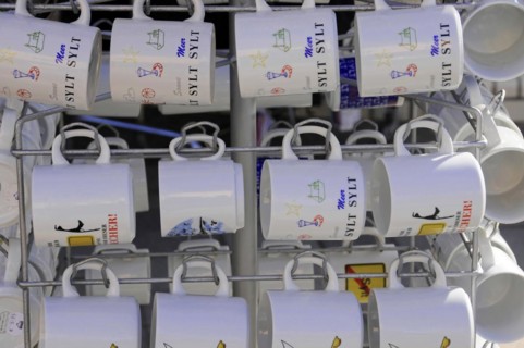 Sylt, North Frisian Island, Schleswig-Holstein, White cups hanging on a rack with various Sylt