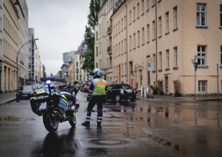Policewoman with motorbike blocks road, taken during a demonstration in Berlin, 19/04/2024