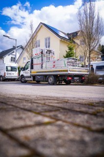 A delivery van with building materials is ready for work, solar systems construction, trade,