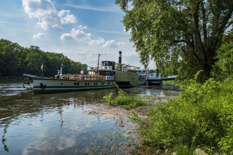 The historic paddle steamer KURORT RATHEN has docked at the steamer landing stage in Pillnitz,
