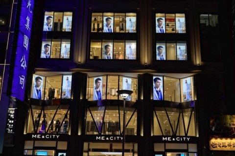 Shanghai by night, China, Asia, Night view of an illuminated shop with fashion presentation in the