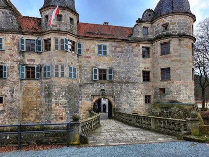 Mitwitz moated castle under a cloudy sky. Mitwitz, Kronach, Upper Franconia, Bavaria, Germany,