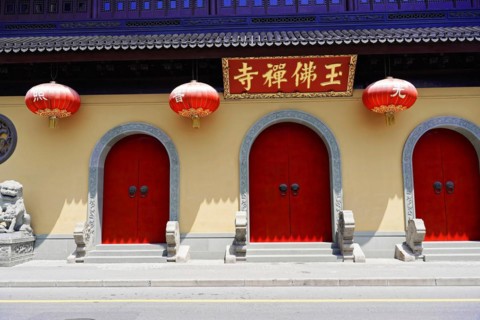 Jade Buddha Temple, Shanghai, Red doors and lanterns on a wall with traditional Chinese