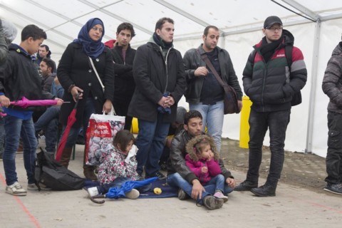 A Syrian refugee family and their children wait in a tent at the Berlin State Office for Health and