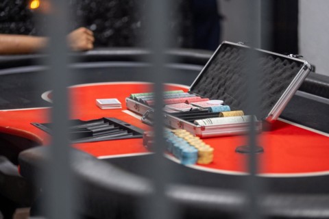 Close-up of a poker table with chips and a poker case, symbolising the excitement of the game,