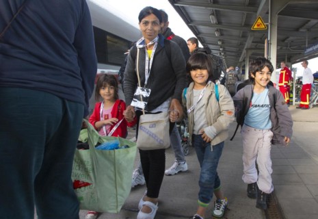 Syrian refugees have arrived at Schoenefeld station on a special train. They are then taken by bus