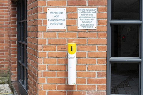 Distribution of flyers prohibited, warning sign on a brick wall on an architectural building in the