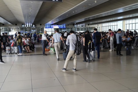 Hongqiao Railway Station, Shanghai, China, Asia, Travellers waiting in a brightly lit airport area,