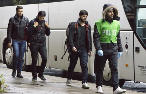 Refugees have arrived at Schoenefeld station on an IC train. They are then taken by bus to