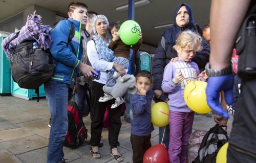 Syrian refugees have arrived at Schoenefeld station on a special train. They are then taken by bus