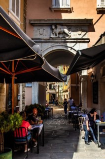 Old town alley with Venetian lion at the gate, harbour town Piran on the Adriatic coast with