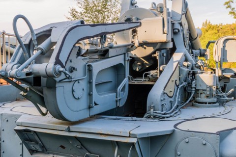 Rear view of camouflaged tank with Closeup view of ammunition loader used to load shells into gun