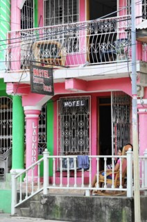 San Juan del Sur, Nicaragua, A colourful hostel building with wrought iron balconies in an urban