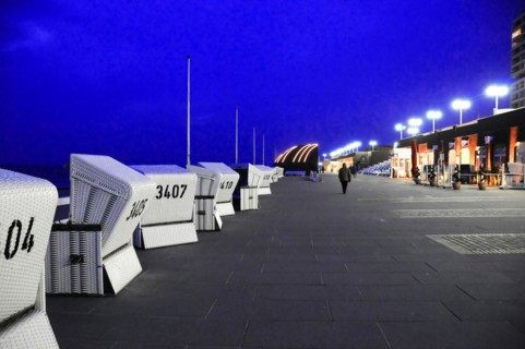 Evening, Westerland, Sylt, Schleswig-Holstein, row of beach chairs on a promenade at night with one