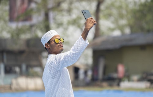 GUWAHATI, INDIA, APRIL 11: A Muslim person takes selfie after perform Eid al-Fitr prayer at Eidgah