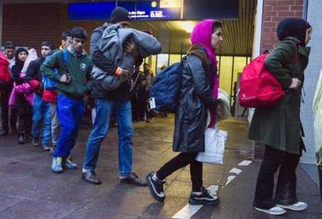 Refugees have arrived at Schoenefeld station on an IC train. They are then taken by bus to