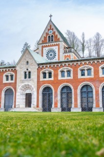 Historic church with Gothic style and brick facade under a cloudy sky, Bad Reichenhall, Alte