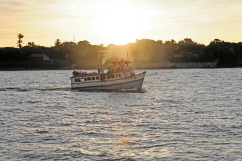 Lake Nicaragua, Ometepe Island in the background, Small boat on a lake at sunset, with light