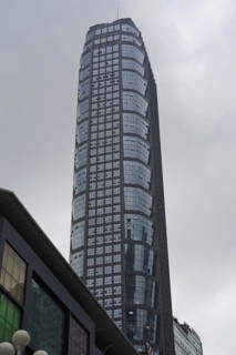 Chongqing, Chongqing Province, China, Asia, A large skyscraper with a glass facade towers into the