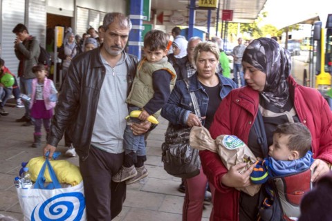Syrian refugees have arrived at Schoenefeld station on a special train. They are then taken by bus