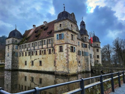 Mitwitz moated castle under a cloudy sky. Mitwitz, Kronach, Upper Franconia, Bavaria, Germany,