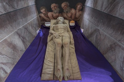 Reclining figure of Christ in the Holy Sepulchre, behind a motif of three men in purgatory, St
