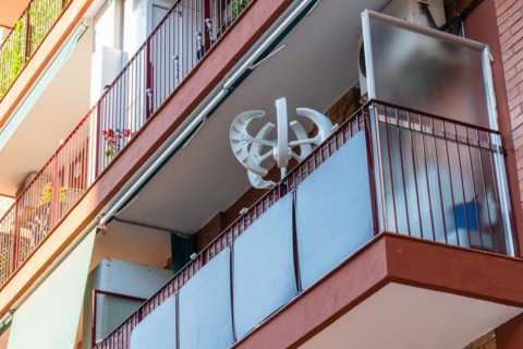 Balcony power plant and mini wind turbine on a balcony of a high-rise building in Barcelona, Spain,