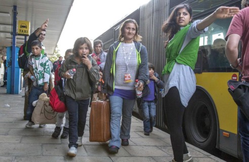 Syrian refugees have arrived at Schoenefeld station on a special train. They are then taken by bus